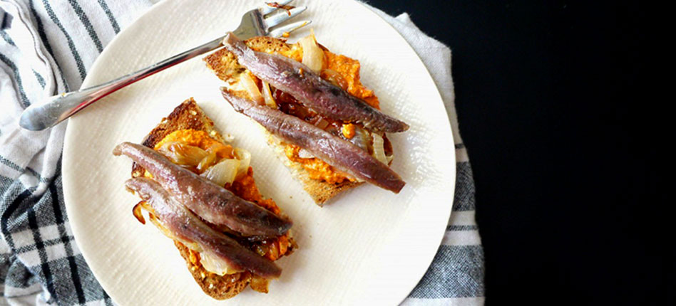 TAPAS Anchovy toasts with caramelized onions and pimientos recipe