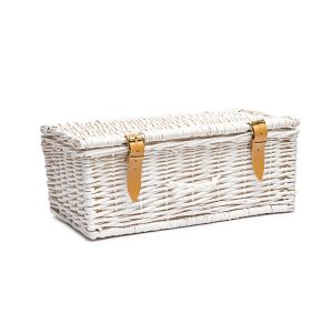 Empty white wicker hamper with leather strips